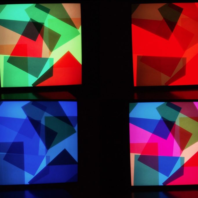 Abstract geometric shapes in vibrant colours of red, green, blue, and pink.